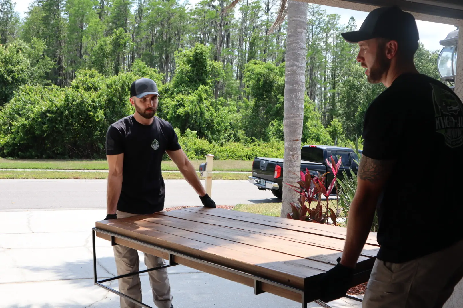 Single Item Junk Removal two men removing a table